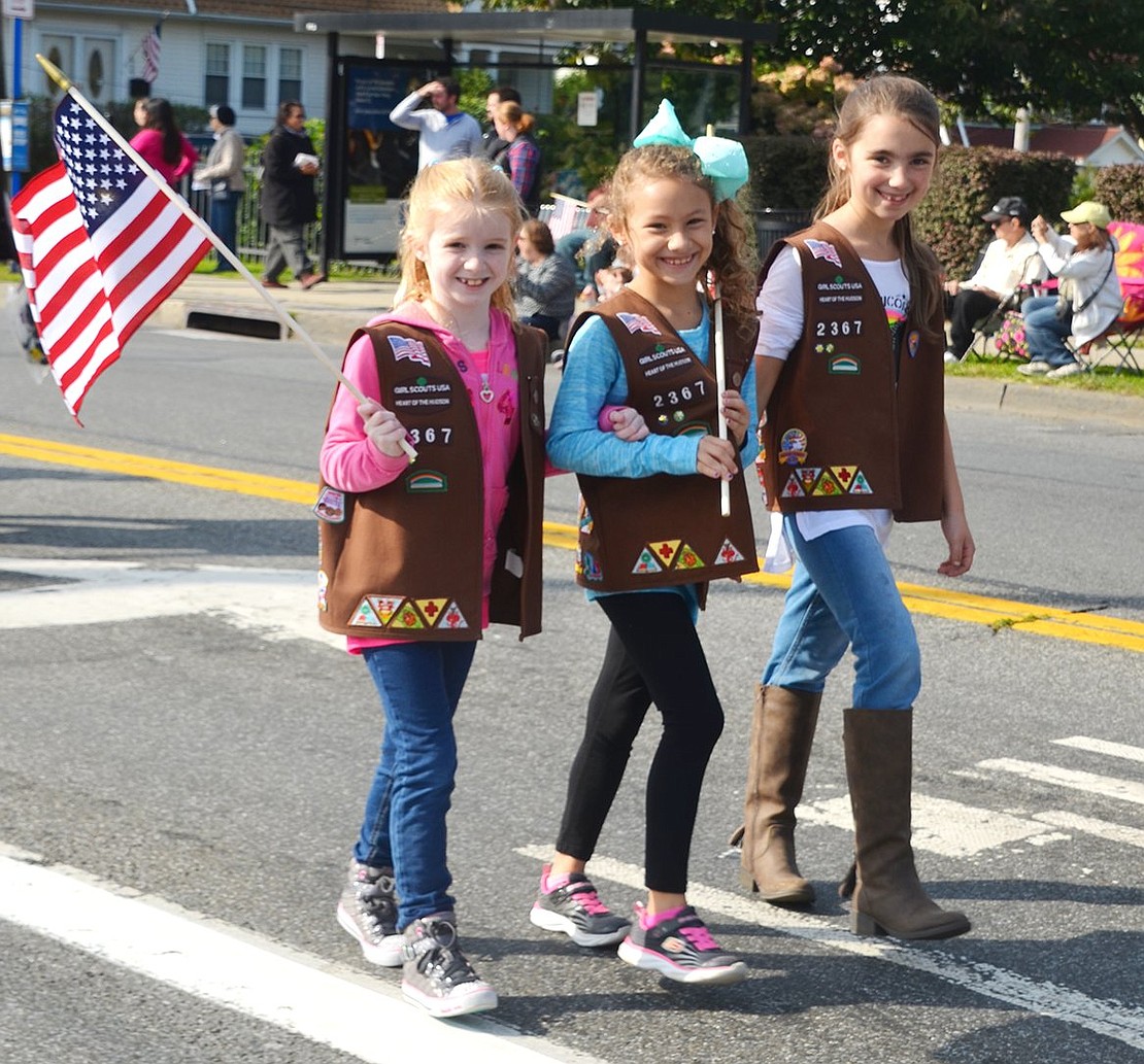 <p class="Picture">Port Chester Brownie Troop 2367 members Kelly Pascale, Sophia Moore and Maya Scher make their way along the parade route.</p>