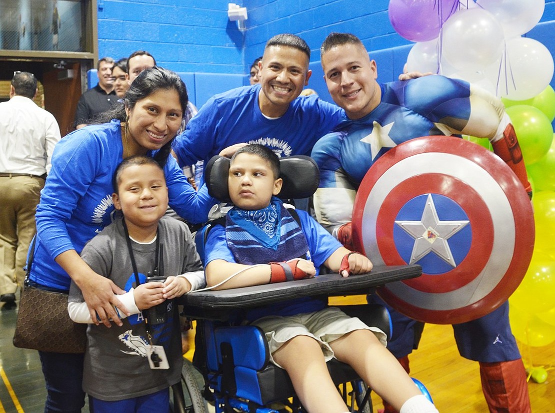 <p class="Picture">The Rojas family poses with Mike Ortiz, a school counselor, who was dressed like Captain America.</p>
