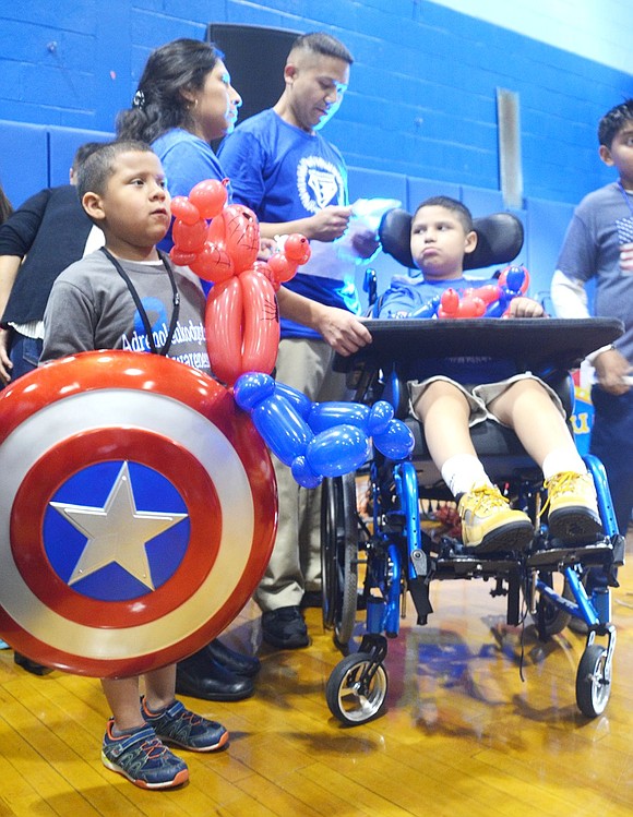 <p class="Picture">Brian Rojas stands with his new Captain America shield, given to him by sixth grade special education teacher Jeff Tascio, and a balloon shaped like his favorite superhero Spiderman.</p>
