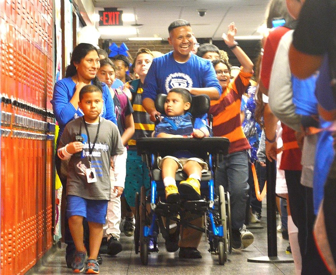 <p class="Picture">Led by the Rojas family, hundreds of smiling Port Chester Middle School students walk the lower halls of the school on Friday, Oct. 21 to show their support for 6-year-old Brian and 9-year-old Brandon, who were diagnosed with the rare genetic disorder Adrenoleukodystrophy in 2014.&nbsp;</p>