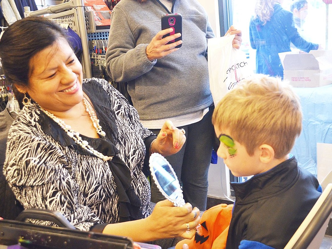 <span style="font-family: Arial;">Seven-year-old Joseph Bauman of Maywood Avenue gets his face painted to look like a zombie.&nbsp;</span>