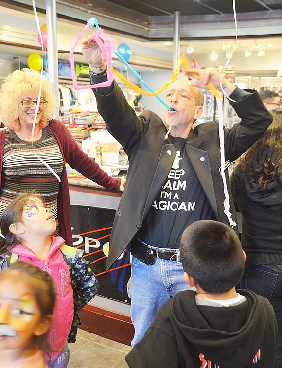 <span style="font-family: Arial;">Magician Richie &ldquo;Magic&rdquo; wows children by pulling an endless rope of colorful rags out of his mouth.&nbsp;</span>