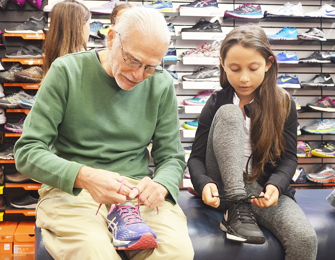 <p class="Picture">Talia teaches Sportech owner Mel Siegel the secret behind her shoe tying technique. The 8-year-old from Scarsdale uses two finger movements to tie her shoes in under four seconds. Talia&rsquo;s demonstration was one of many events Sportech hosted during their celebration of 25 years selling sporting goods at the Rye Ridge Shopping Center on Saturday, Oct. 22.&nbsp;</p> <p class="Byline">Photo Story By Casey Watts</p>