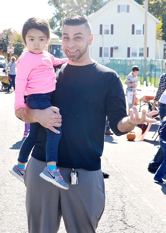 <p class="Picture">Before they purchase tickets to play games, Rye Brook residents Nick Rao of Westview Avenue holds his 3-year-old daughter Isabella.</p>