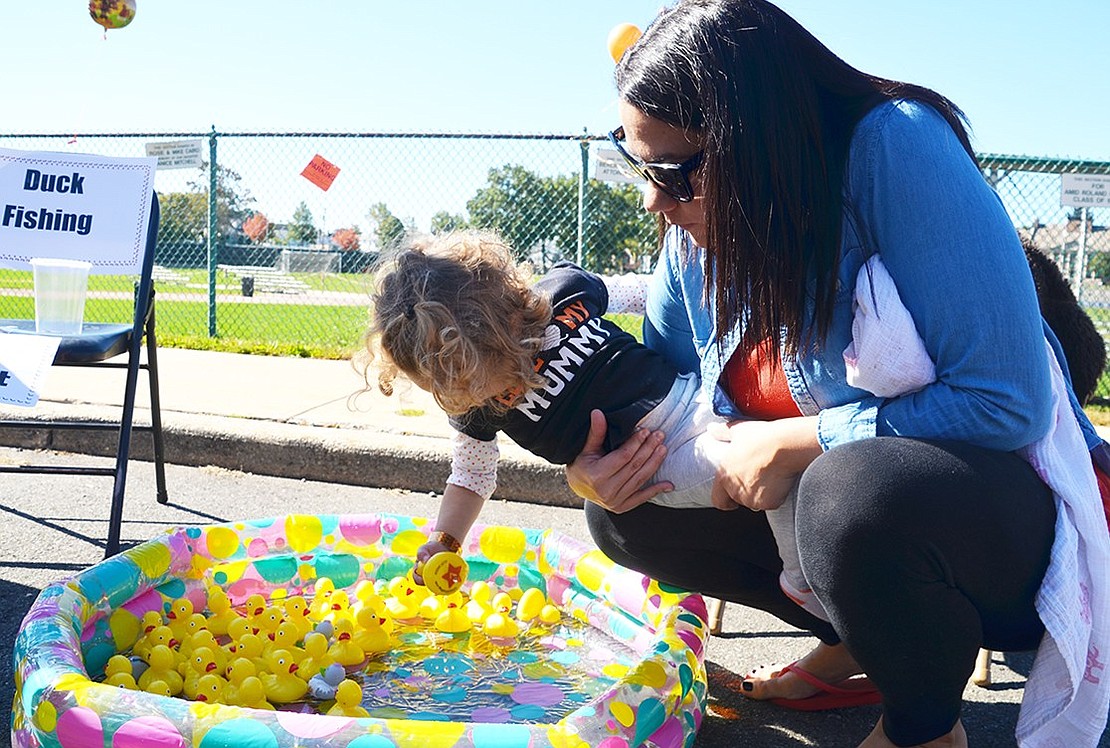 <span style="font-family: Arial;">Two-year-old Sophia Bonvino and her mother Sarah of Madison Avenue pick rubber ducks for tickets.</span>