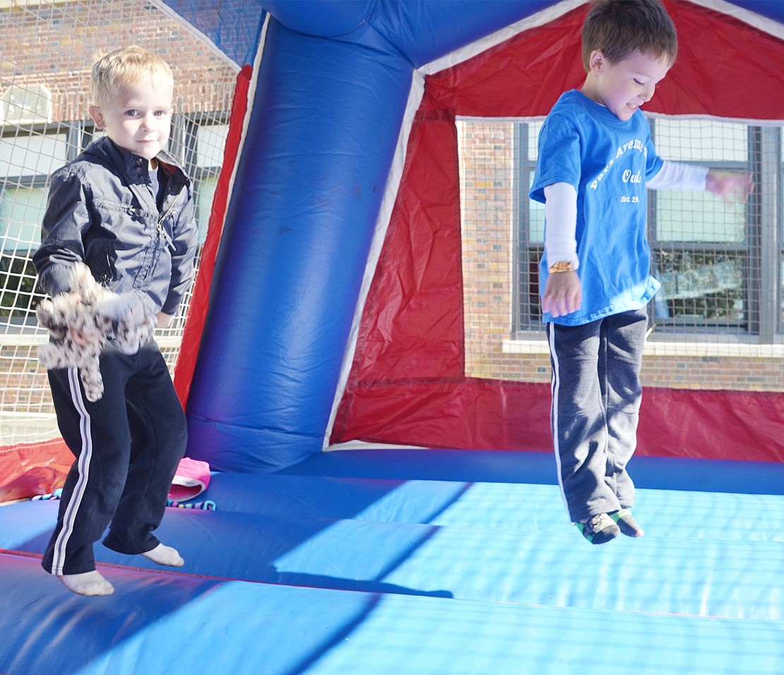 <p class="Picture">Colin Hollwedel, 4, of Park Avenue and his friend Emmett Vakil, 5, of West Glen Avenue jump together in the bounce house.&nbsp;</p>