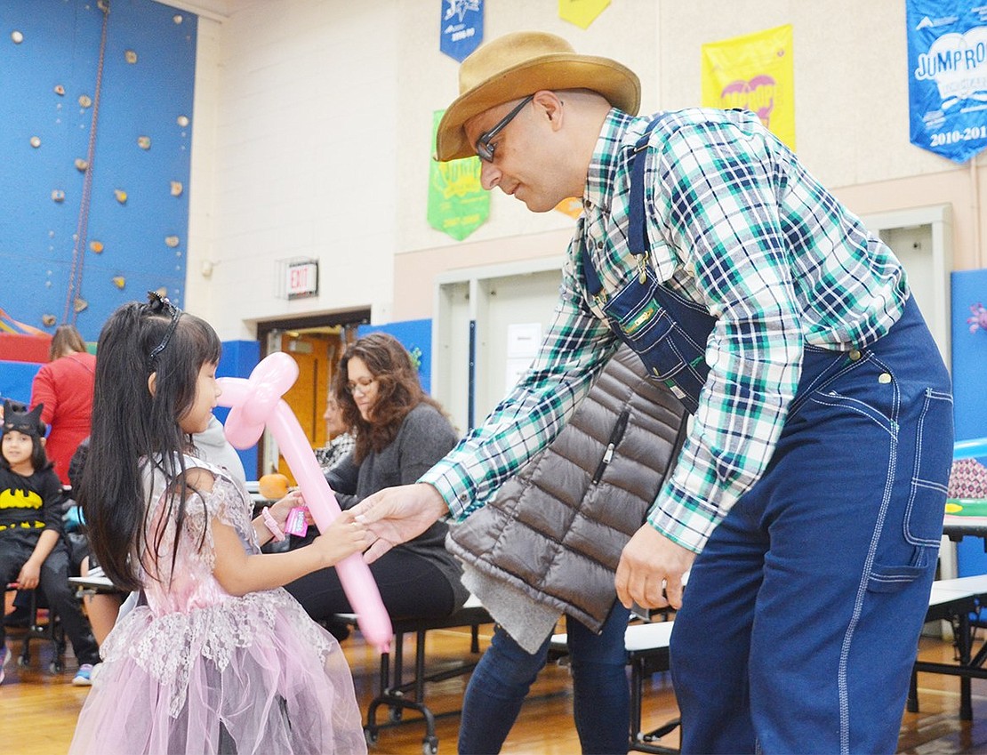 <p class="Picture">Joseph Mas of Perry Avenue hands Princess Natalie Diaz, a kindergartener, a pink flower made out of a balloon.&nbsp;</p>