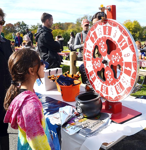 <p class="Picture">Fourth grader Abby Goldstein of Lawridge Drive tries her luck at Sotheby&rsquo;s International Realty table. She spun an &ldquo;8,&rdquo; which won her a medium size prize.&nbsp;</p>