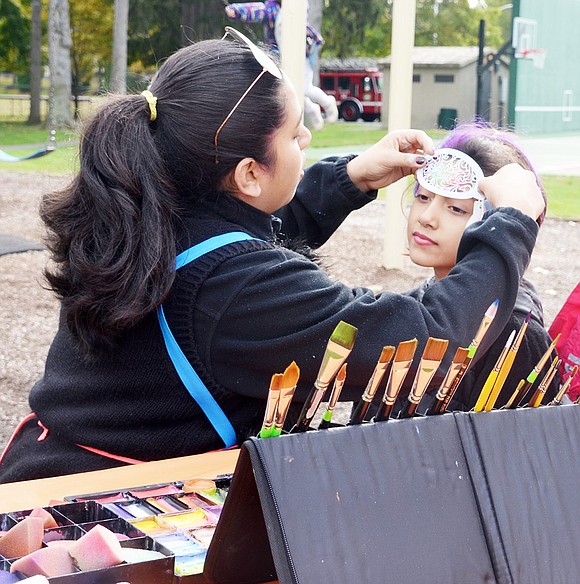 <p class="Picture">Port Chester Girl Scout Madeline Saunders of Troop 1982 gets a rainbow design painted on her face by Creative Face Painting&rsquo;s Claudi Benitez of White Plains. &nbsp;</p>