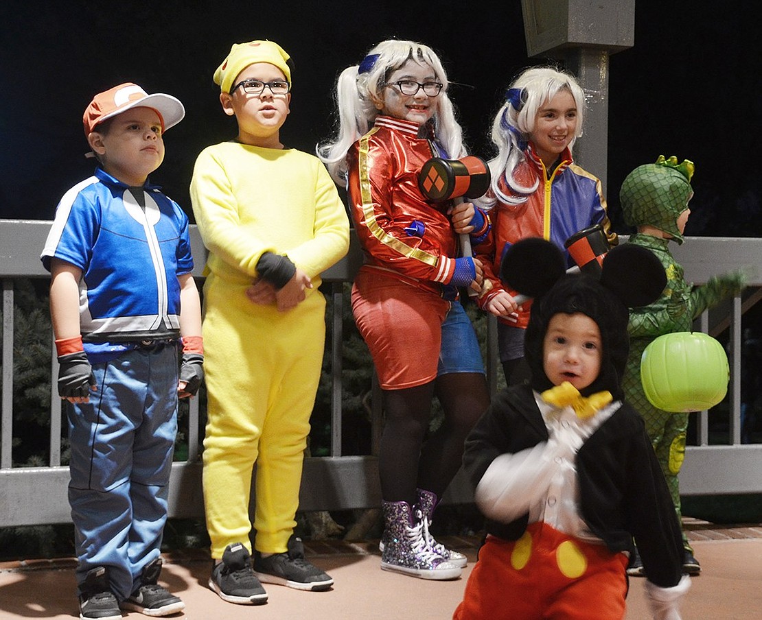 <span style="font-family: Arial;">Two Harley Quinns, Ash Ketchum, Pikachu and a reptile pose while Mickey Mouse runs in front.&nbsp;</span>