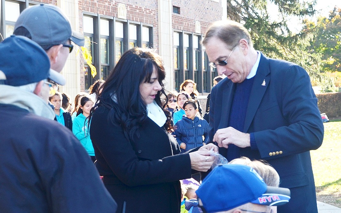 <p class="Picture">Town of Rye Supervisor Gary Zuckerman hands out American flag pins with the word &ldquo;veteran&rdquo; on them to those who served or who had family who served.&nbsp;</p>