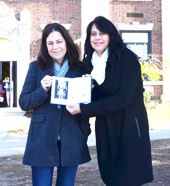 <p class="Picture">Sisters Jennifer Cammarotta and Joanne Cammarota Vinci pose with a photo of their deceased father, Joseph &ldquo;Red&rdquo; Cammarota. A short biography of him is found in one of the almost 100 books donated to Park Avenue School by retired Port Chester Middle School teachers Hank and Isabelle Birdsall.&nbsp;</p>