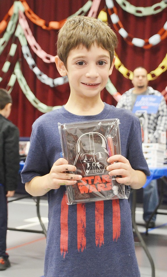 <p class="Picture">First grader Michael Rigano admitted that he only wanted the &ldquo;Star Wars&rdquo; journal for the light saber pen that came with it.&nbsp;</p>