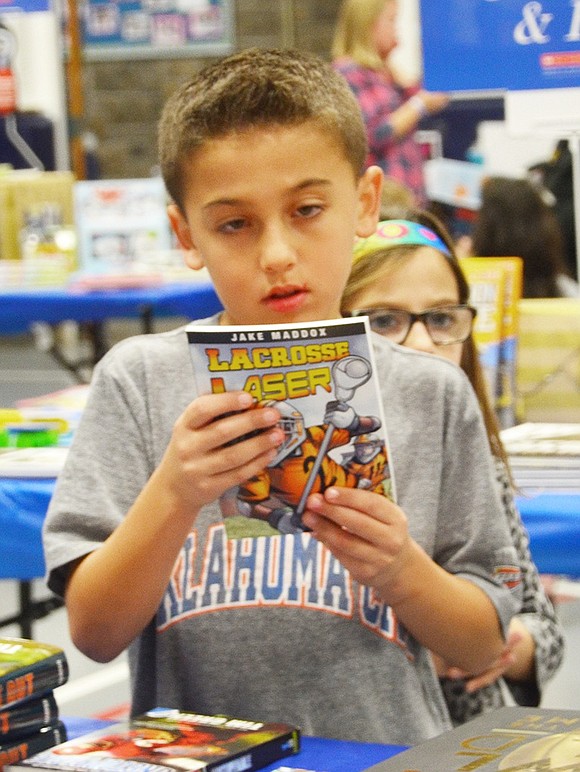 <span style="font-family: Arial;">Fourth grade sports enthusiast Jack Gold reads the summary of &ldquo;Lacrosse Laser.&rdquo;</span>