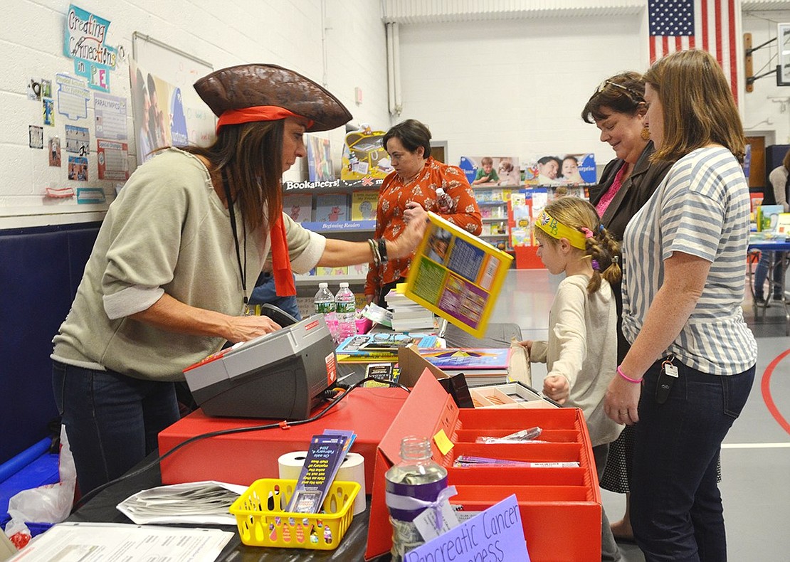 <p class="Picture">Ridge Street School volunteers dressed up as pirates sell books to excited students.&nbsp;</p>