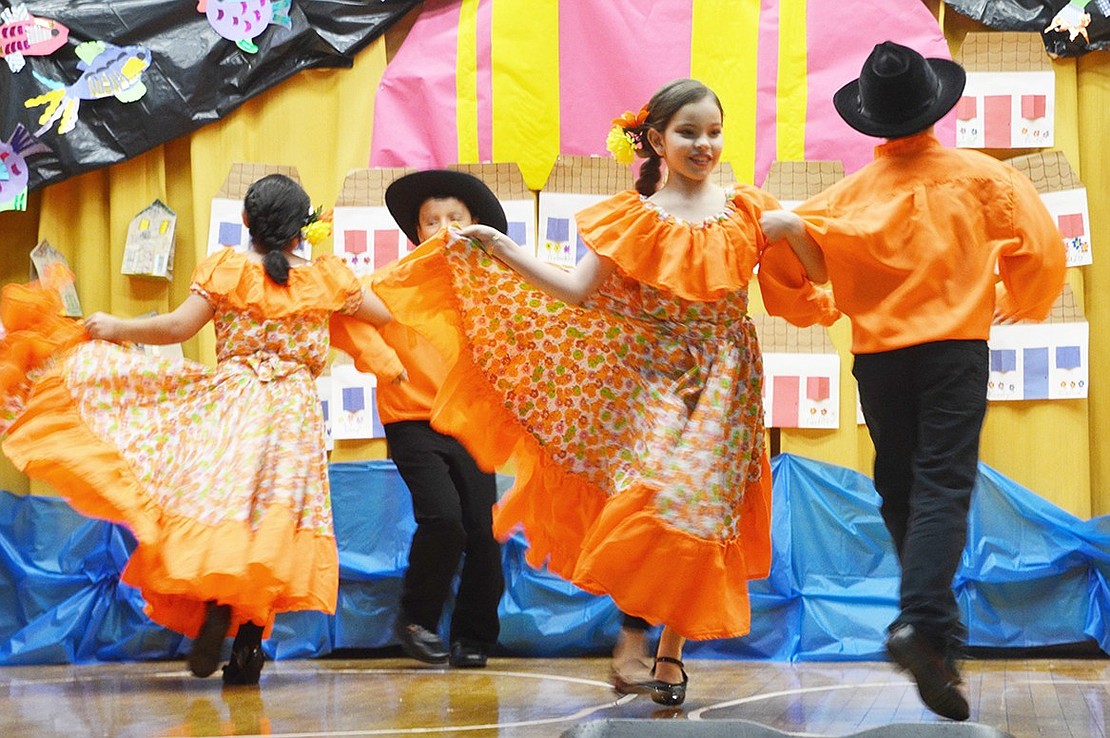 <p class="Picture">Thomas A. Edison Elementary School first graders perform &ldquo;Granja de Edison&rdquo; during Hispanic Heritage Night on Friday, Nov. 18. The girls twirled in billowing orange dresses and the boys looked dashing in black hats.&nbsp;</p> <p class="Byline">Photo Story By Casey Watts&nbsp;</p>