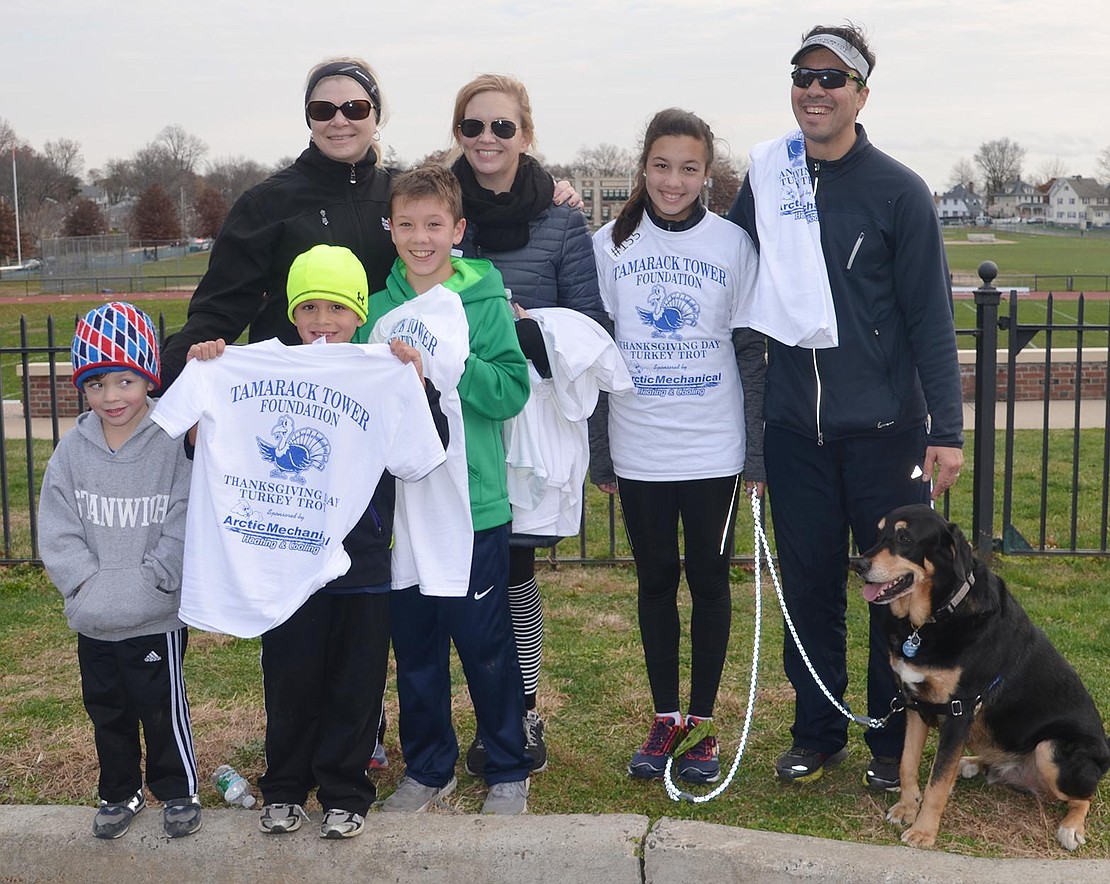 The Hoemann family of Valley Terrace pose with their Tamarack Tower Foundation T-shirts after the race. Front row, from left: Asher, 5, Alden, 7, who won a prize for being the youngest runner, Anders, 12. Back row, from left: Cynthia Hoemann, cousin Karine Aure of Wyoming, Ainsley, 14, Andy and their dog.