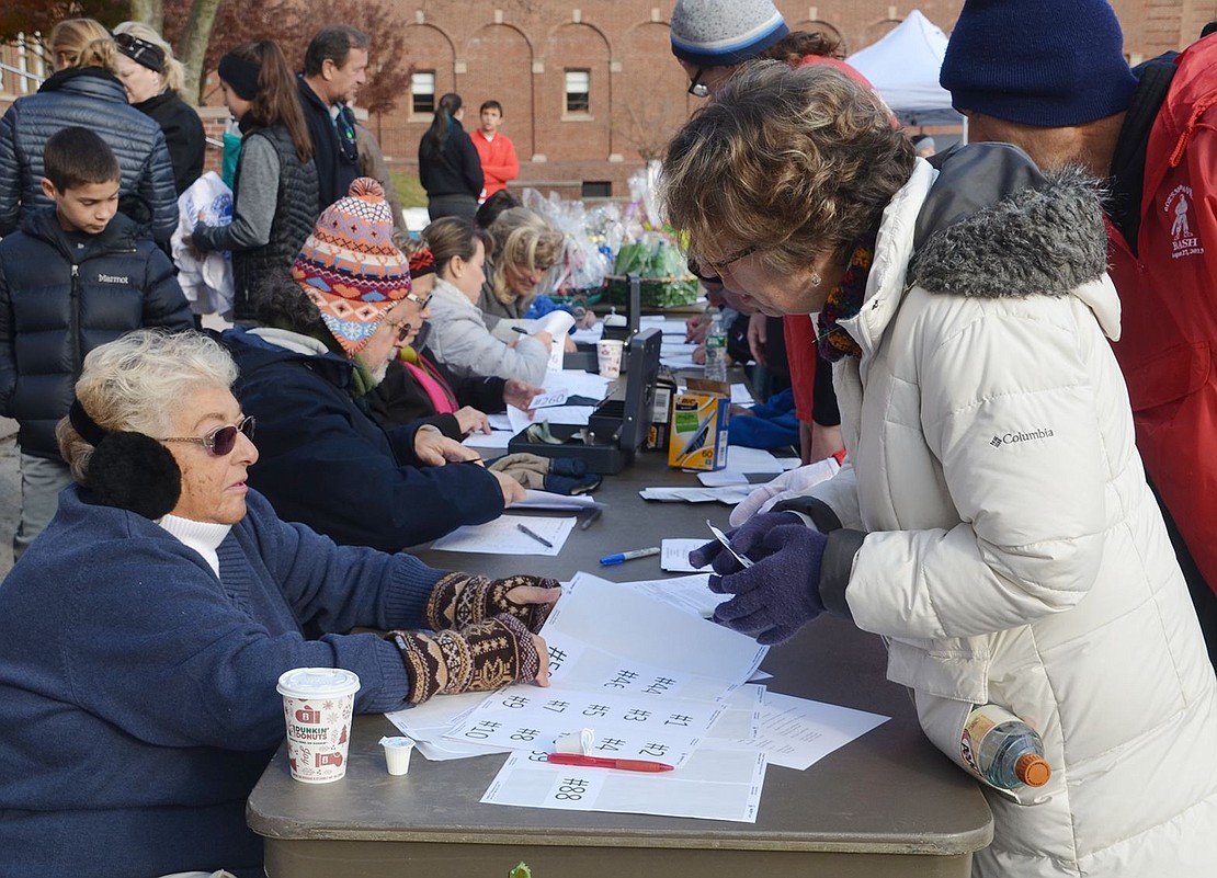 <p class="Picture">Rosemarie Barone (front) and other Tamarack Tower Foundation volunteers sign up Turkey Trot participants. Two hundred seventy-seven runners, walkers and joggers took part, raising $8,375 for scholarships and other grants to support the Port Chester schools. That included a $750 donation from sponsor Arctic Mechanical and $1,200 raised by the elementary schools that held Tiny Turkey Trots in their gym classes.</p>