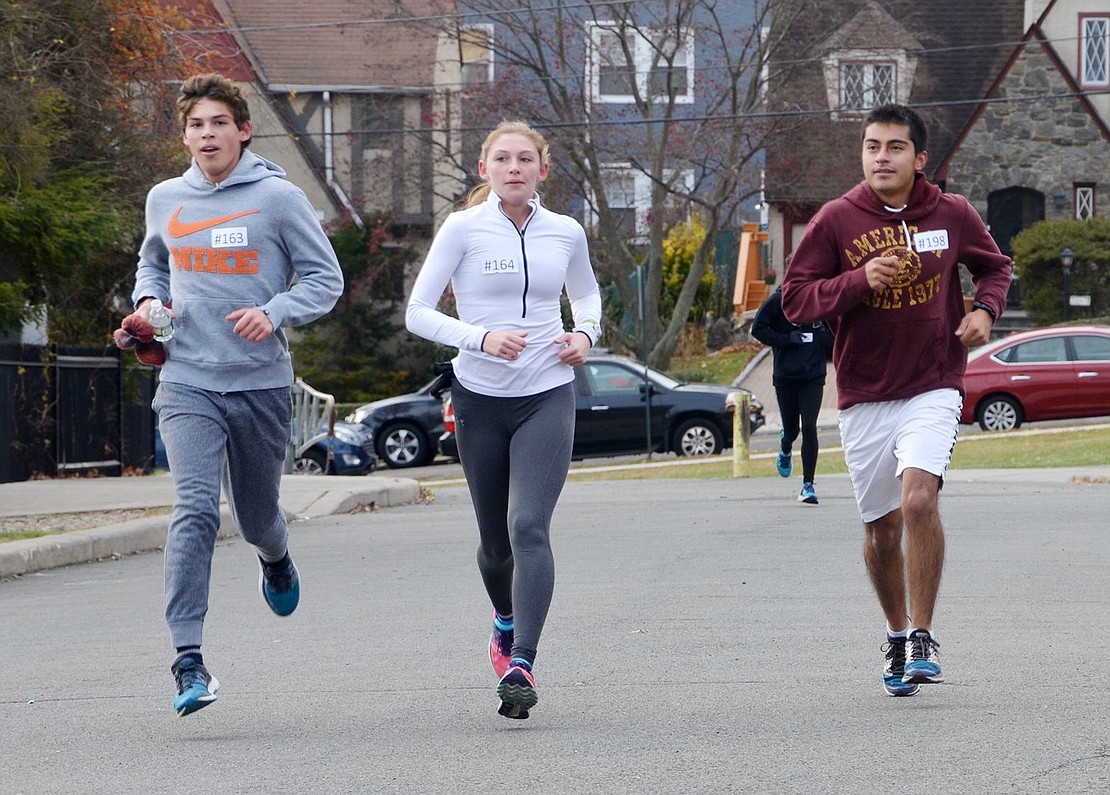 <p class="Picture">Recent Port Chester High School graduates Leonard Pietrafesa, Brooke Pietrafesa and Zuriel Arellano run up the driveway at the high school toward the finish line of the Tamarack Tower Foundation&rsquo;s Turkey Trot on Thanksgiving morning. The race was dedicated to Bea Pietro, a former runner and avid supporter of the Port Chester schools who died during the past year.</p>