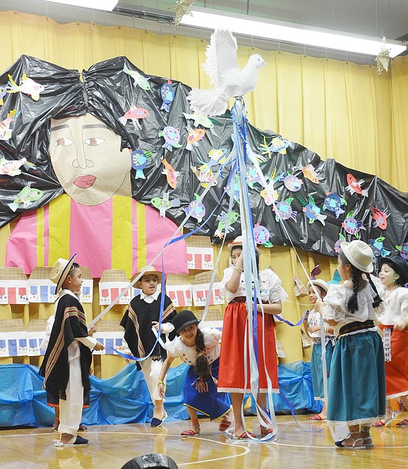 Second graders danced around a pole to the Ecuador song "La Paloma."