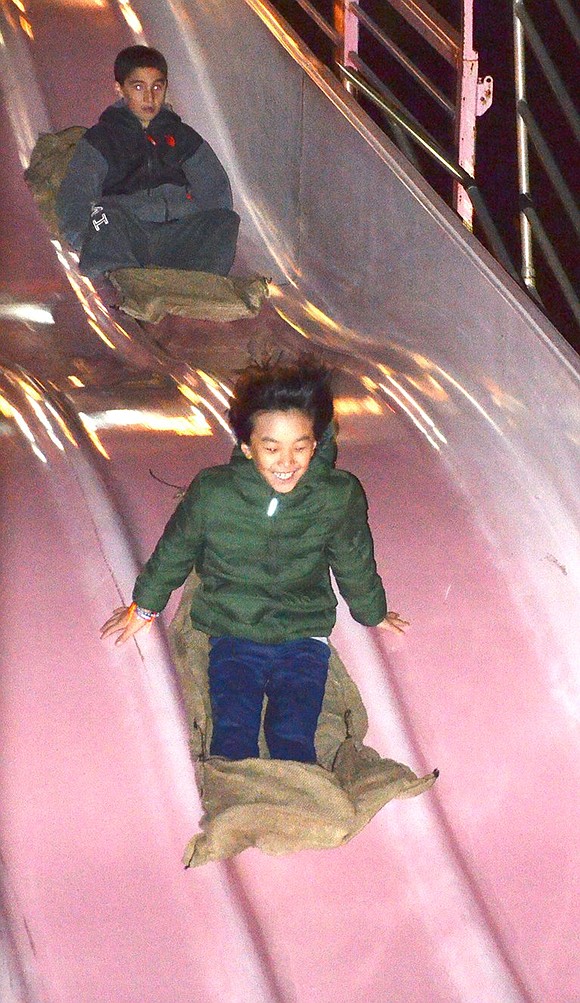 <p class="Picture">Rye Brook 9-year-olds Daniel Schutzer and Billy Oh race down the giant slide. Oh was the clear winner.&nbsp;</p>