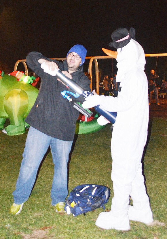 <p class="Picture">Rye Brook Recreation Department&rsquo;s Rocky Furano loads the tee shirt gun for Frosty the Snowman, also known as Justin DiSanto from the Village&rsquo;s Parks Department.&nbsp;</p>