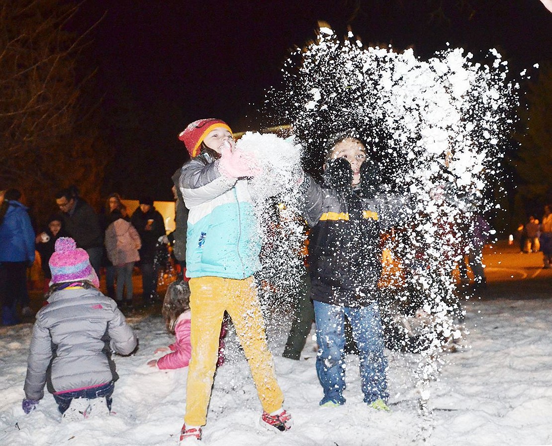 <p class="Picture">Kids were more than happy to play in the fake snow while their parents waited in lines for food, pictures with Santa, or the train ride.&nbsp;</p>