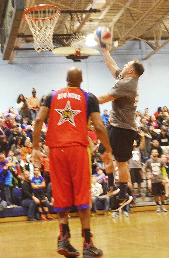 <p class="Picture">Port Chester 8<sup>th</sup> grade Social Studies teacher Frank Carlson shows off his jumping skills with a layup.&nbsp;</p>