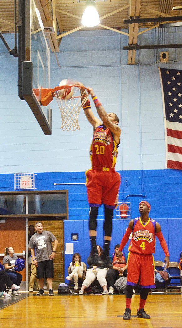 <span style="font-family: Arial;">Hi-Rise, No. 20, dunks the basketball while teammate Road Runner watches.&nbsp;&nbsp;</span>