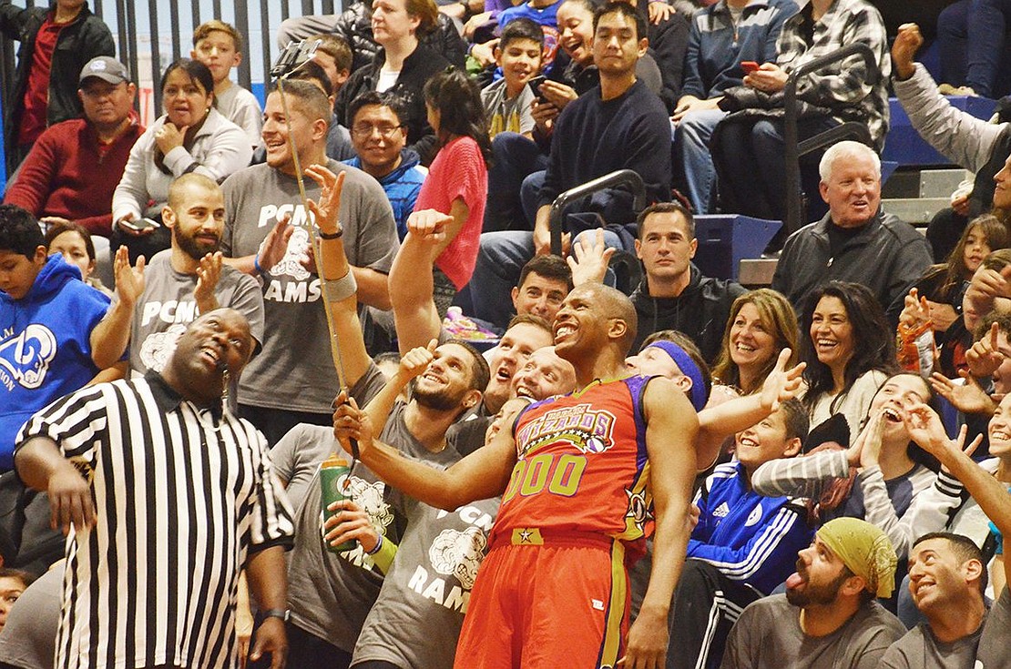 <span style="font-family: Arial;">Swoop, No. 000, takes a selfie with the crowd.&nbsp;</span>