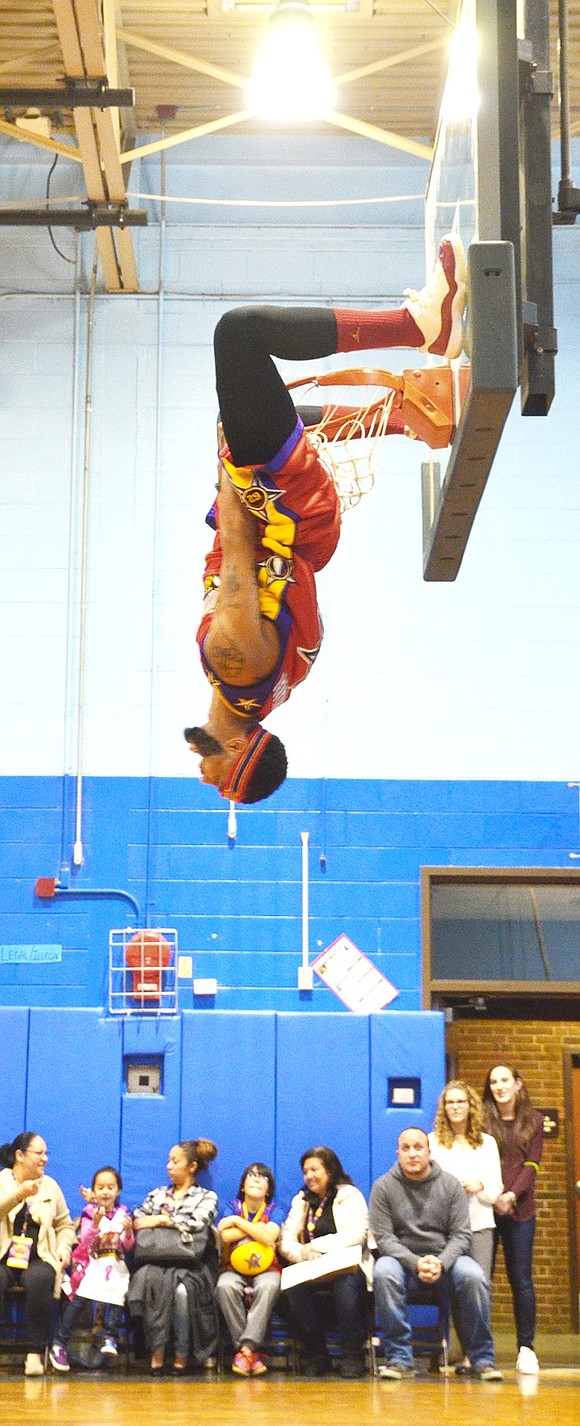 <p class="Picture">Team member Sky Walker, No. 7, shows off his strength after dunking the basketball.&nbsp;</p>