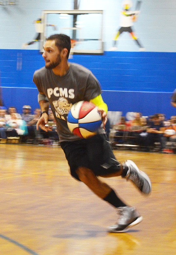 <p class="Picture">Del Bianco Academy teacher aide James Puma dribbles the ball, desperate to get in a basket before the buzzer ends the third quarter.</p>