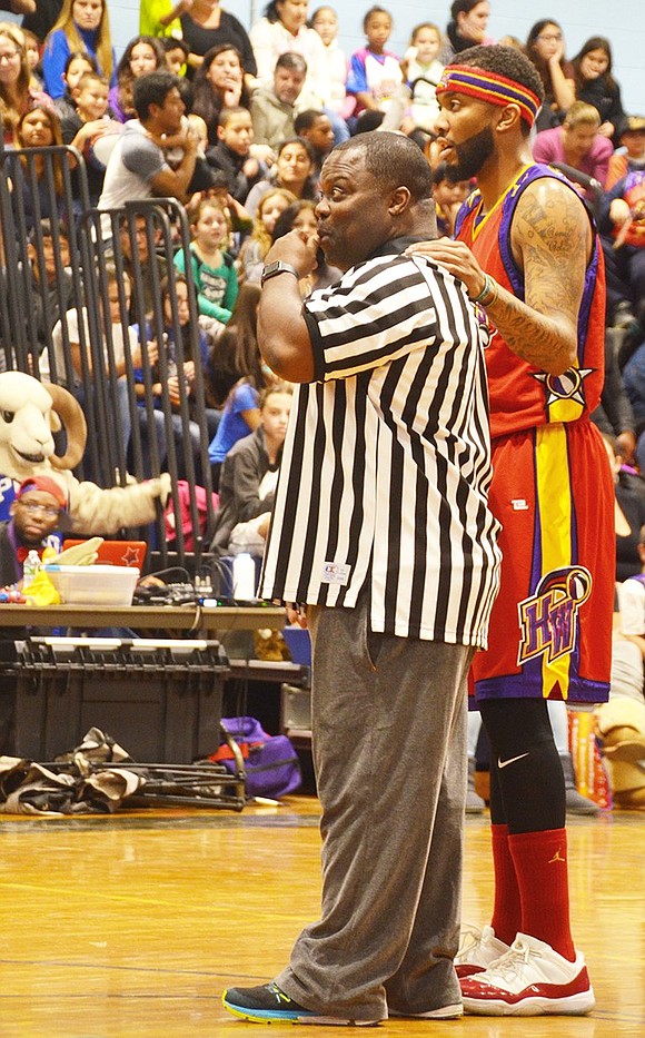 <p class="Picture">Referee and Port Chester Middle School Assistant Principal Byron Womack calls a travel on one of the Harlem Wizards&rsquo; players.&nbsp;</p>