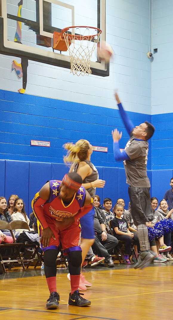 <p class="Picture">Ivan Tolentino, principal at Thomas A. Edison School, goes in for a layup to bring the Rams up to an early lead. The Rams might have lost the game 48-79, but the students were the real winners &ndash; all of the ticket proceeds went directly to the PCMS PTA.&nbsp;</p>