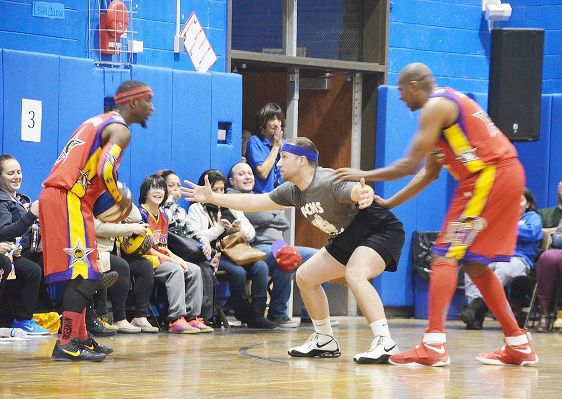 <p class="Picture">Eighth grade math teacher Kevin Hanlon gets some help with his defense skills, during the Port Chester versus the Harlem Wizards basketball game at Port Chester Middle School on Thursday, Dec. 1. The first step to being a great defenseman is to tuck in your shirt and pull up your shorts as high as they&rsquo;ll go, according to the Harlem Wizards.&nbsp;</p>