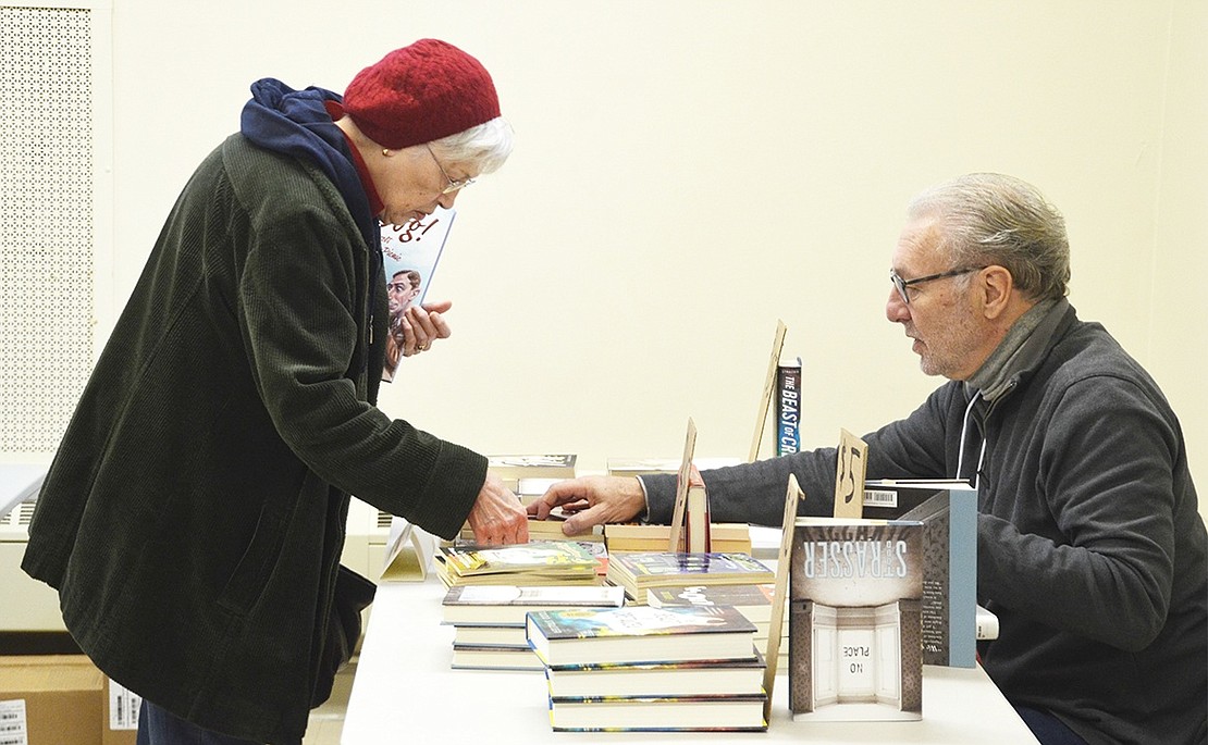 <p class="Picture">Port Chester resident Linda Armstrong converses with author Todd Strasser. Armstrong complimented Strasser and called him a &ldquo;wonderful person,&rdquo; and thought the book festival was &ldquo;a fabulous idea.&rdquo; She was more than excited to be able to buy Strasser&rsquo;s books and get them signed for holiday gifts.&nbsp;</p>