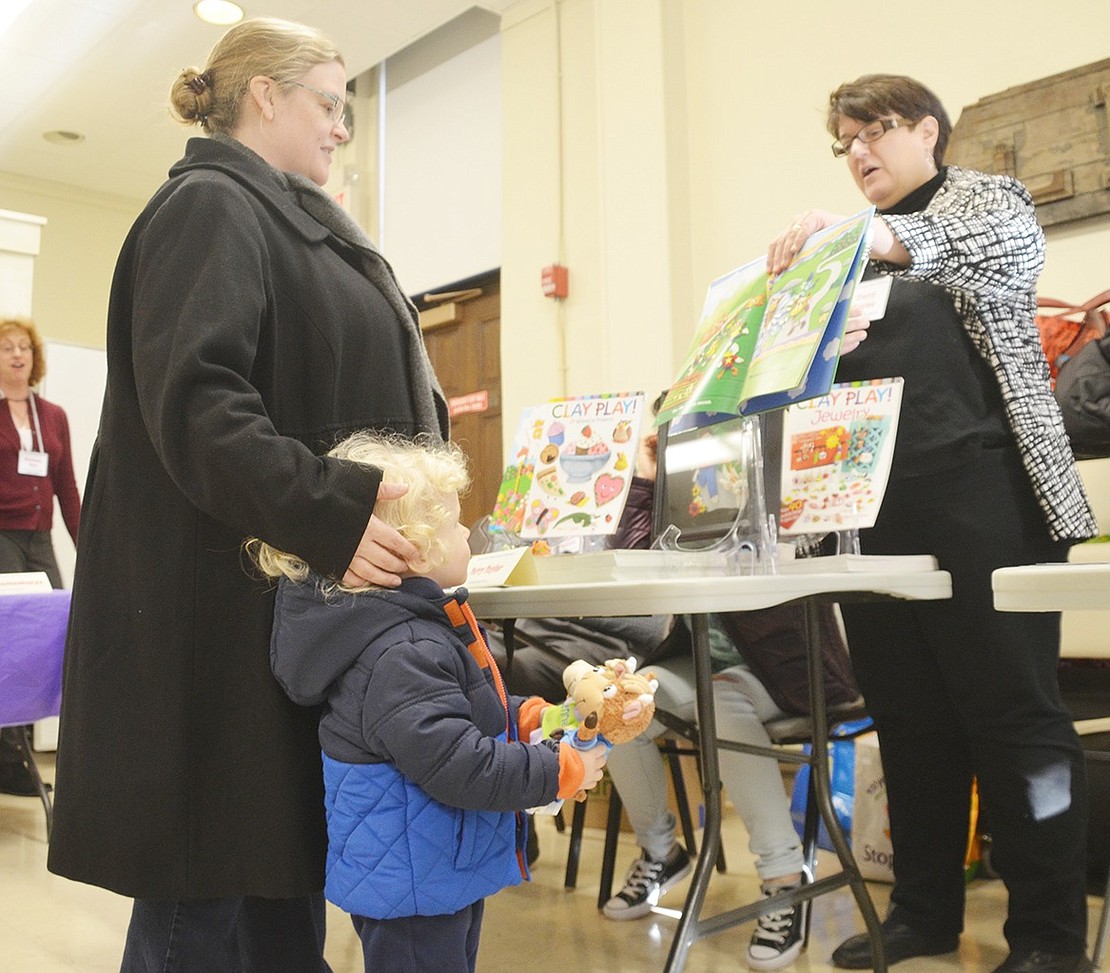 <p class="Picture"><span style="font-family: Arial;">Two-year-old Port Chester resident Jack Zlabinger is in awe of Terry Taylor&rsquo;s colorful clay photographs and her two character plush dolls. His mother Lesley talks with Taylor about how she makes her illustrations&nbsp;during the Port Chester-Rye Brook Public Library&rsquo;s first Local Authors Book Festival on Saturday, Dec. 3.&nbsp;</span></p> <p class="Byline"><span style="font-family: Arial;">Photo Story By Casey Watts</span></p>