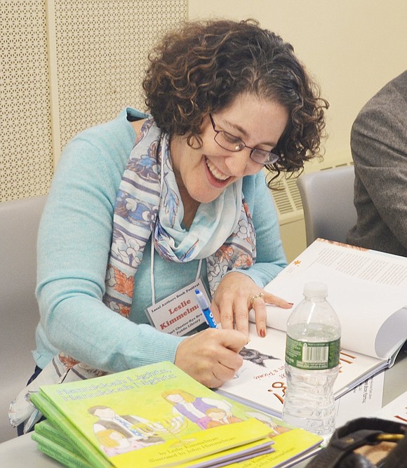 <p class="Picture">Leslie Kimmelman of Ardsley signs her books for a customer.&nbsp;</p>