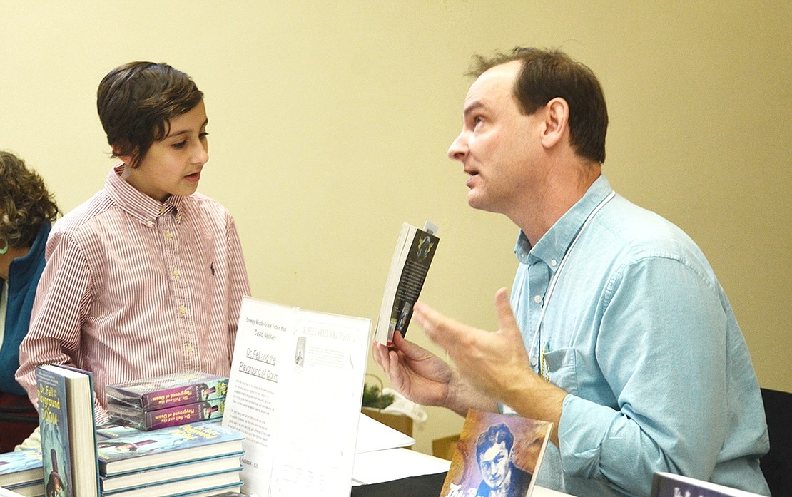 <p class="Picture">Tarrytown author David Neilsen explains his book &ldquo;Dr. Fell and the Playground of Doom&rdquo; to 10-year-old Harper Kelsey of Peekskill.&nbsp;</p>