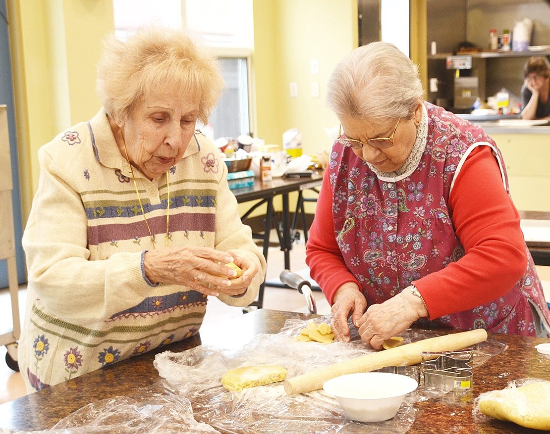 <p class="Picture">About 10 Rye Brook Seniors helped coordinator Elizabeth Rotfeld bake and decorate hundreds of Christmas cookies at the Anthony J. Posillipo Center on Wednesday, Dec. 21. Marion Stephens of Avon Circle and Anna Amaturo of Louis Court work on rolling and cutting the dough into snowflakes, stars, trees and snowmen. Photo story by Casey Watts</p>