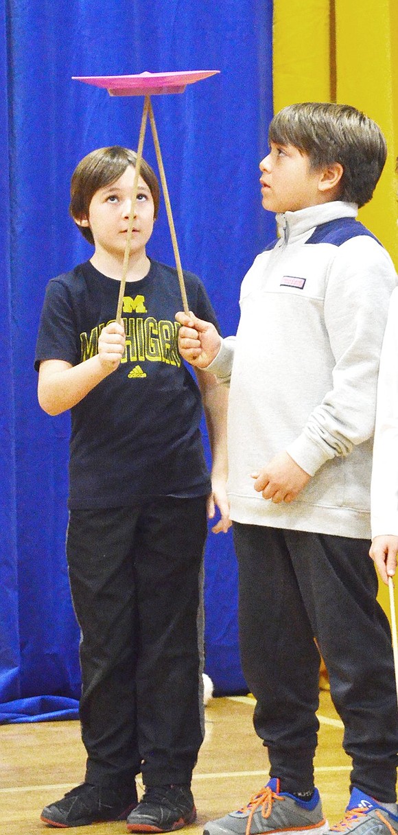 <p class="Picture">Connor Landsman passes a spinning plate on a stick to Harrison Kuznetzow. </p>