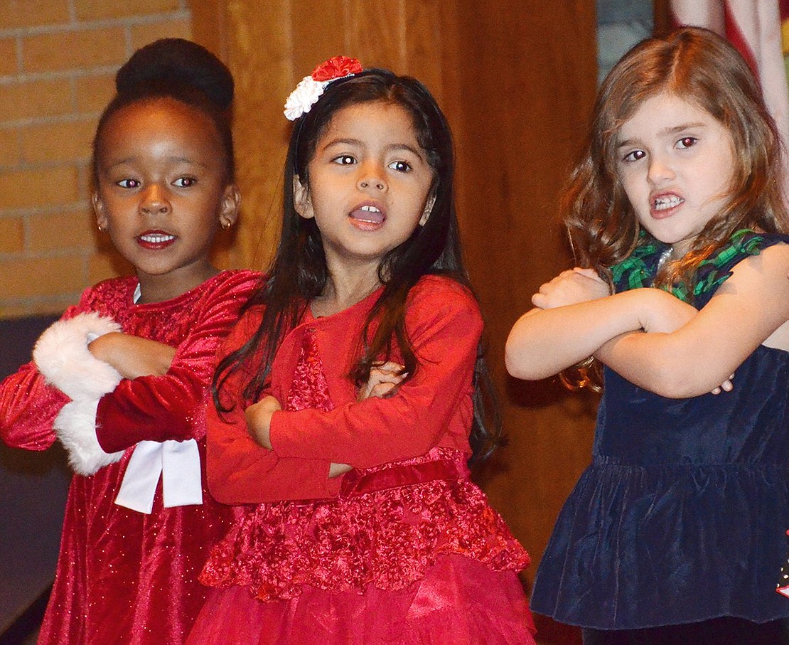 <p class="Picture">From left, Isabella Carey, Aileen Umanzor and Lorenn Drakefords, 4-year-olds in Pre-K 4, do a rendition of &ldquo;Santa Claus is Coming to Town.&rdquo;</p>