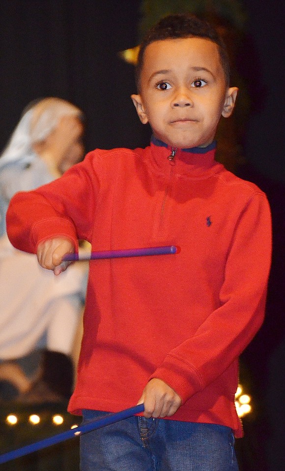 <p class="Picture">Kindergartner Mason Jimenez taps his sticks together in time to the music of &ldquo;The Little Drummer Boy.&rdquo;</p>