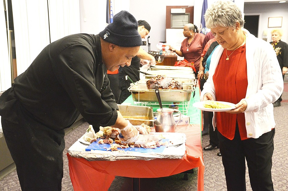 <p class="Picture">A buffet with freshly carved ham that seniors said melted in their mouth as well as chicken and sides was a highlight of the party. Here caterer Esmerito Henriquez slices the ham for Mary Young.</p>