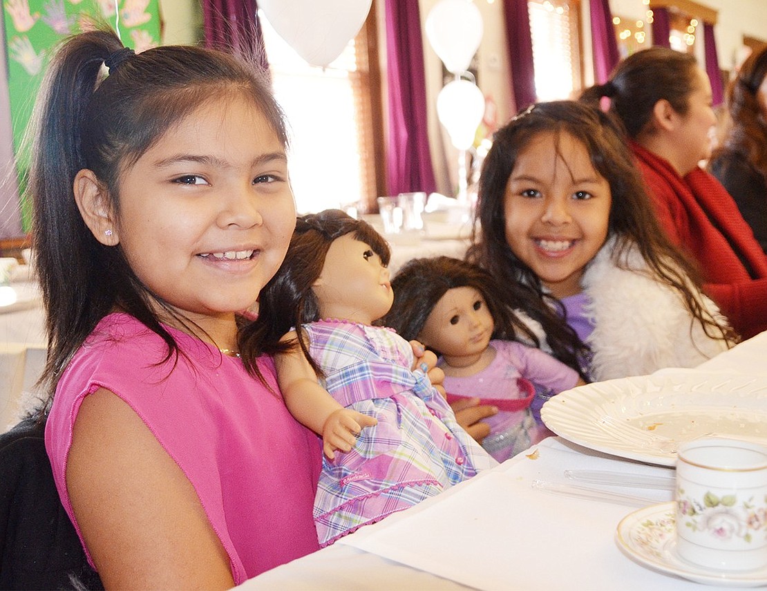 <span style="font-family: Arial;">Port Chester 8-year-olds Lyndsay Arroyo and Briana Conde pose with their dolls.&nbsp;</span>