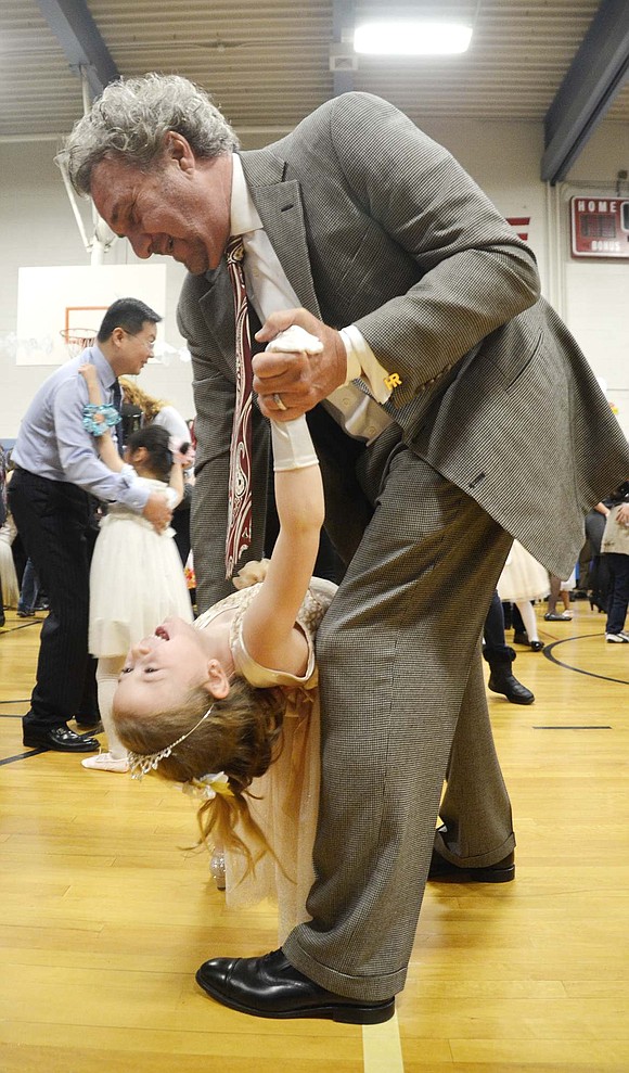 <span style="font-family: Arial;">Danielle Elkowitz squealed with laughter every time her uncle, Howie Rosen, dipped her.&nbsp;</span><span style="font-family: Arial;">Bruno M. Ponterio Ridge Street School&rsquo;s gym was filled with twirling skirts and top hats during the first grade Snowball on Friday, Jan. 20. Because the event was held in the downstairs gym, all of the first grade classes could dance at the same time. Photo story by Casey Watts</span>