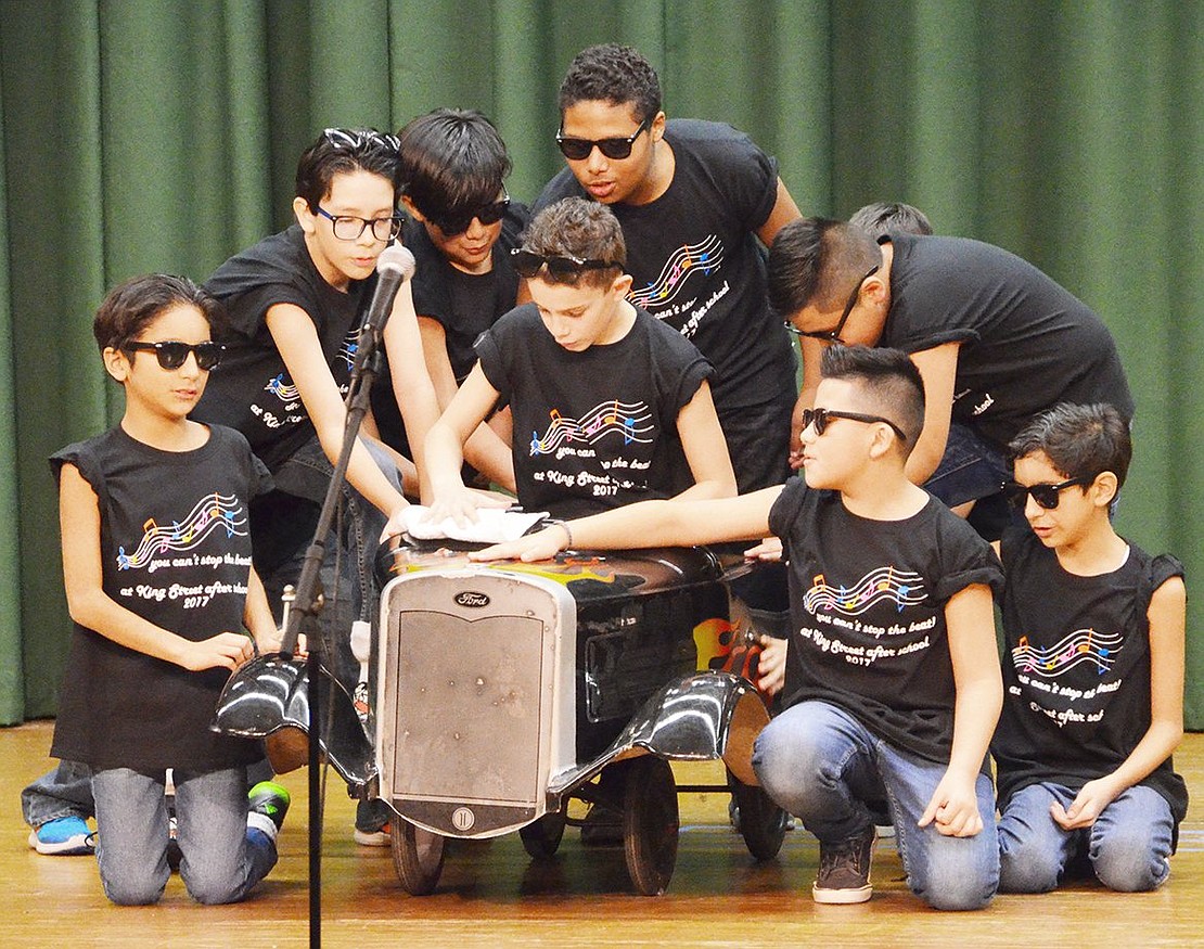 <p class="Picture">The fifth grade boys sure know how to rock the stage as they take care of their hot-rod, &ldquo;Greased Lightning.&rdquo;&nbsp;</p>