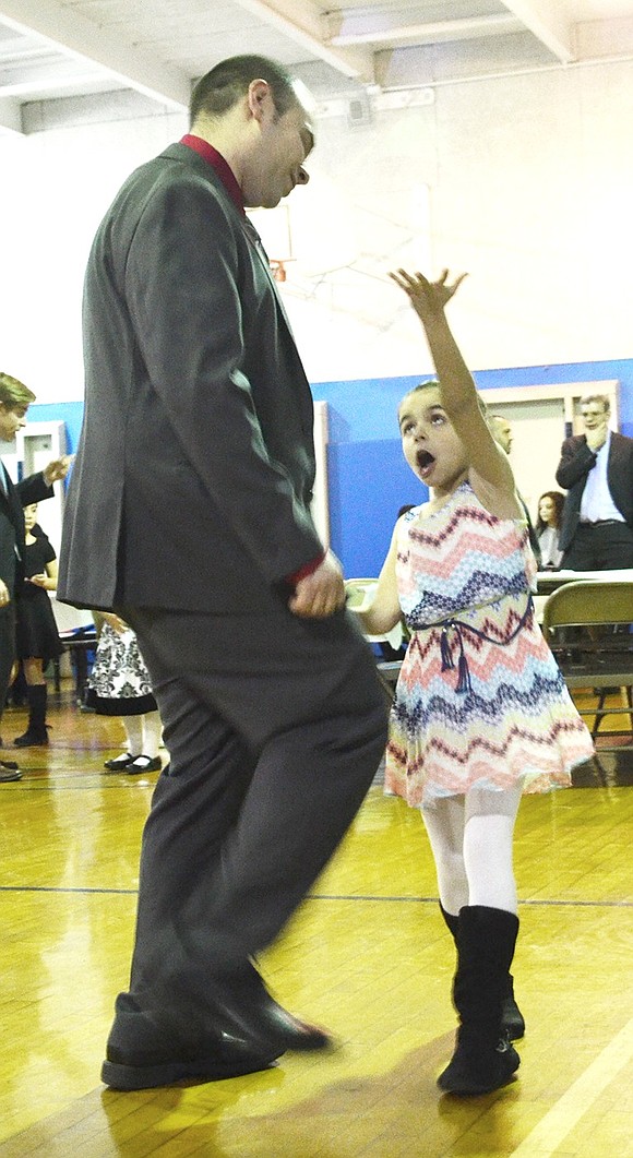 <p class="Picture"><span style="font-family: Arial;">Joe Faraci and his 6-year-old daughter Sophia are the first on the dance floor. Sophia reaches for the sky to teach her dad a couple of new moves.</span></p>