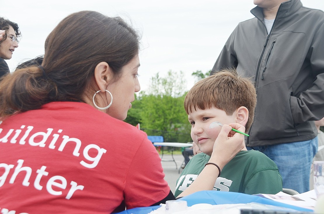 Second grader Joshua Simkin, 8, loves turtles so much that he was getting one painted on his face. 