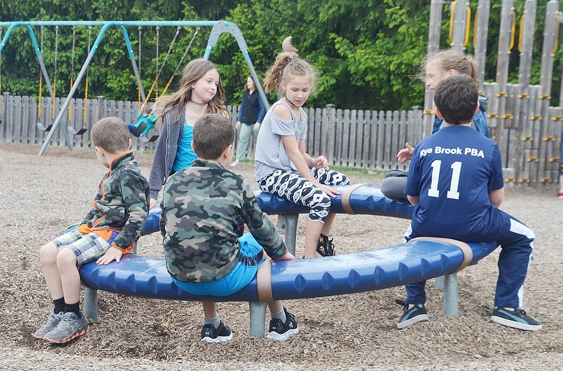 While their parents perused the sale and their classmates sang, Ridge Street School students spent their time on the playground. 